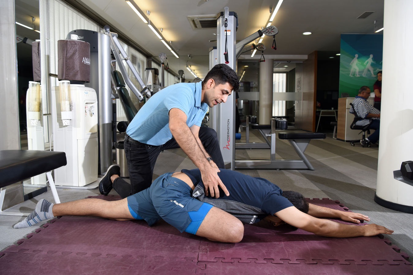 Functional manual therapy with a physiotherapist assisting a client in corrective mobility exercise at a Vardan center