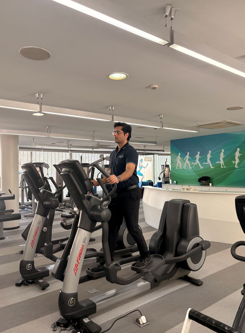 Patient performing low-impact cardio exercise on cross trainer at VARDĀN Physiotherapy Centre Delhi